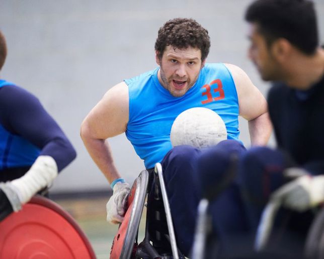 Man in a wheelchair playing a ball sport