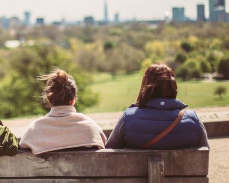Two women looking into the distance on a bench.jpg