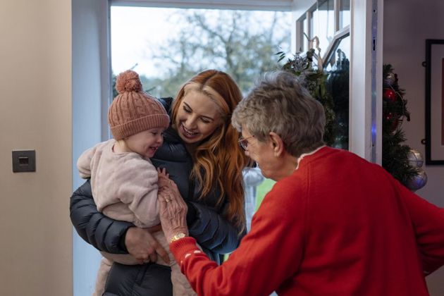 Family being greeted as they enter the front door