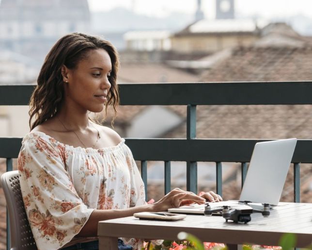 Female working on her work laptop outside.jpg