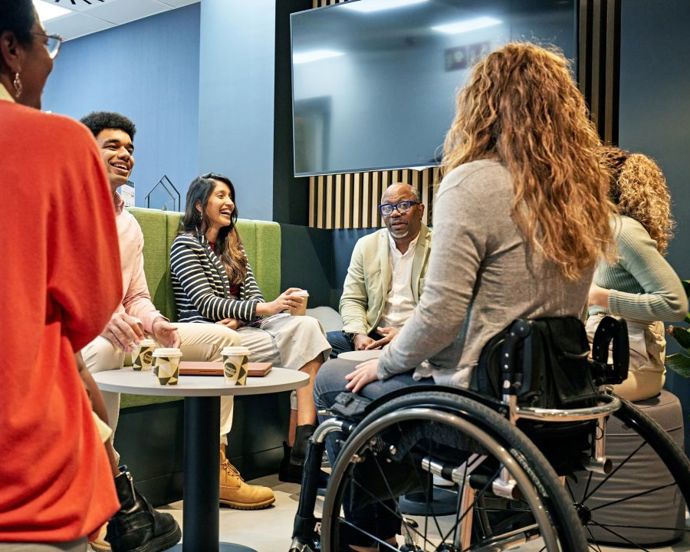 Inclusive team talking around a coffee table