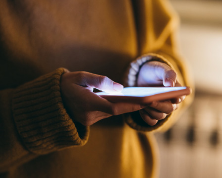 A pair of hands using a smart phone