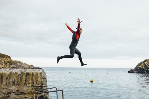 Person confidently jumping off a cliff