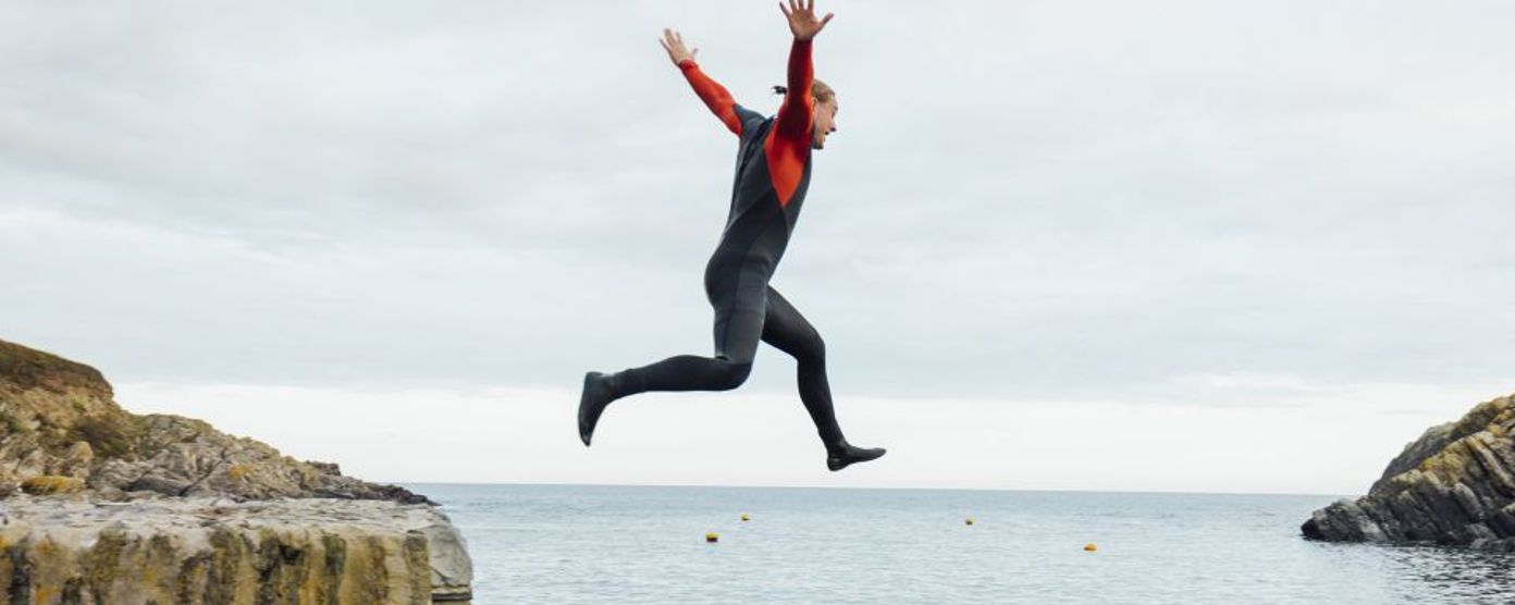 Person confidently jumping off a cliff